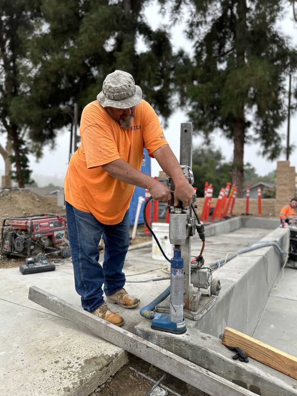 Operator core drilling a foundation slab on a residential job