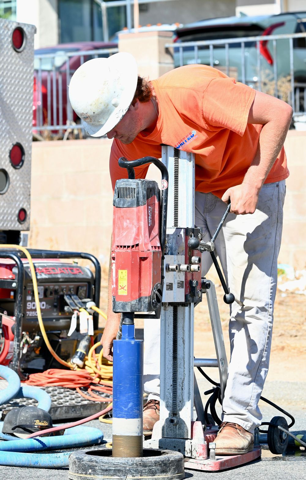 Operator turning the crank on a core drill